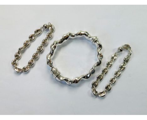 SILVER BRACELETS. A modern silver twist hinged bangle & two silver bracelets with magnetic closures.  Please note that all it