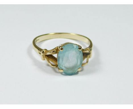 GOLD RING. A modern 9ct. gold dress ring, set a pale blue stone. Size Q/R. Approx. 3g.  Please note that all items in this au