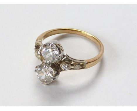 DIAMOND RING. An unstamped, yellow metal ring (probably 18ct. gold) set with two diamonds, each of approx. 0.75ct. spread, ea