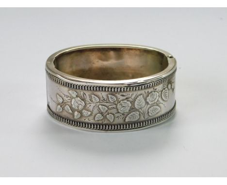 VICTORIAN BANGLE. A Victorian hinged cuff bangle, the clasp stamped 'Duplex Reliance, Robinson's Patent'. The bangle further 