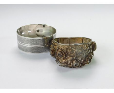 BANGLES. A sterling silver, engine-turned cuff bangle & an ornate filigree, hinged bangle.  Please note that all items in thi