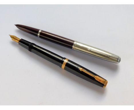 FOUNTAIN PENS. A black Parker Duofold fountain pen with sac filler & 14k N nib. Also, a maroon Parker 51, with stainless stee