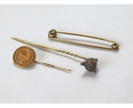 STICK PINS. A Victorian 15ct. gold fox head stick pin, a 9ct. gold English China Clay's lapel pin & a 9ct. gold stock pin. Gr