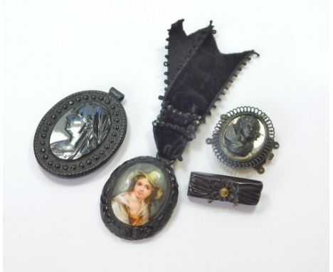 VICTORIAN JEWELLERY. A Victorian moulded composition mourning pendant, one side with a profile of Queen Victoria, the other w