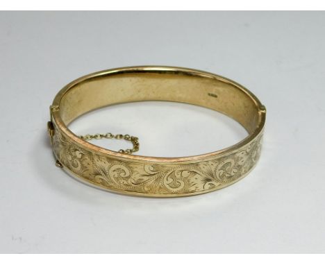 GOLD BANGLE. A 9ct. gold hinged bangle. Approx. 19.78g.  Please note that all items in this auction are previously owned & ar