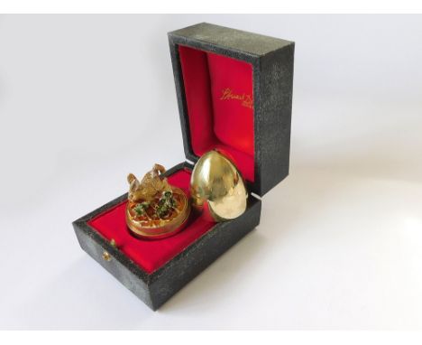 STUART DEVLIN. A Stuart Devlin, textured silver gilt Surprise Egg, opening to reveal a rabbit eating an enamelled carrot on a