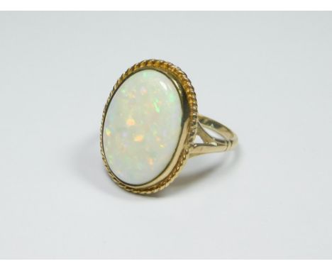 OPAL RING. A 9ct. gold opal dress ring. Approx. 4g. Size O/P.  Please note that all items in this auction are previously owne