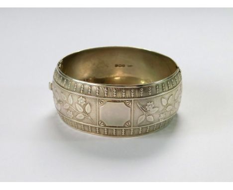 SILVER BANGLE. An early 20th century broad, hinged silver bangle by Clewley & Co., Birmingham 1913.  Please note that all ite