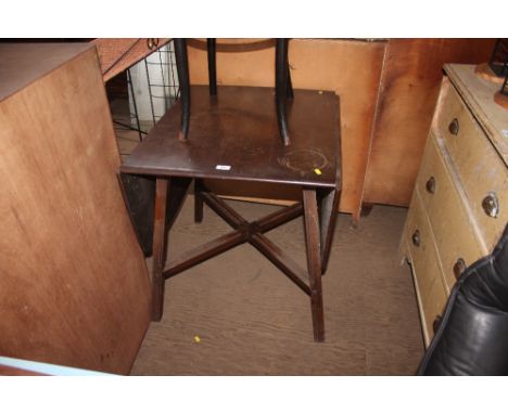 A dark Ercol drop leaf dining table  