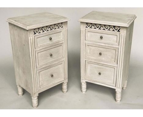 BEDSIDE CHESTS, a pair, French style traditionally grey painted each with three drawers and pierced frieze, 40cm W x 30cm D x