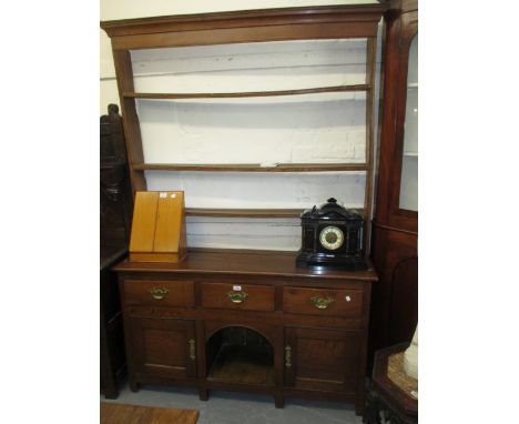 Small George III elm dresser with an open shelf back above three drawers, a central alcove and two cupboard doors