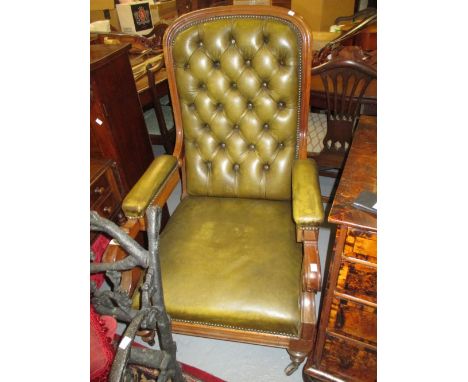 George IV mahogany and green buttoned leather upholstered reclining library armchair, the moulded frame with scroll arms rais