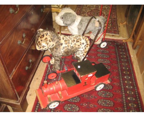 Merrythought push-a-long toy of a leopard and another of a dog, together with a wooden sit-on model steam engine