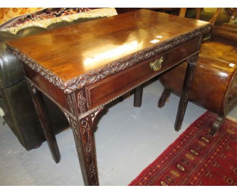 George III rectangular mahogany foldover card table in Chippendale style with a frieze drawer, raised on blind freted chamfer