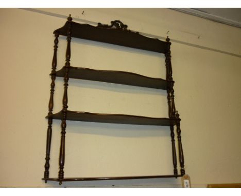 19th Century  mahogany four shelf wall bracket having turned supports and carved pierced surmount