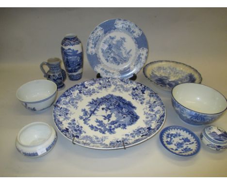 Mintons blue and white pottery charger decorated with figures playing on a swing and various other items of blue and white tr
