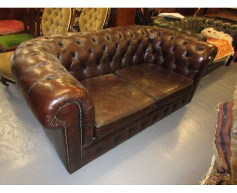 Brown leather button upholstered Chesterfield sofa on bun feet