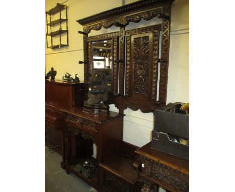 Victorian carved oak hall stand with a mirrored and panel back above drawer with alcove below and a box seat