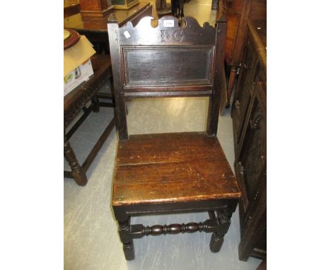 17th Century oak side chair, the rectangular panelled back with shaped surmount carved with the initials I.G., the plank seat