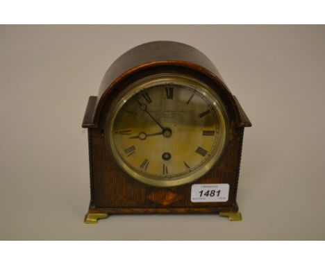 Small oak cased mantel clock with single train movement by Goldsmiths and Silversmiths