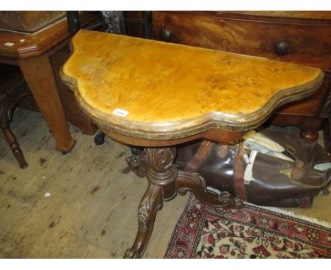 Victorian serpentine shaped walnut fold-over card table on carved column and tripod support