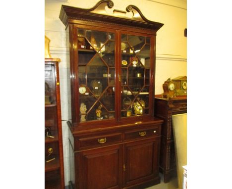 Late Victorian mahogany bookcase with a moulded cornice above two astragal glazed doors, the base with two drawers and two pa