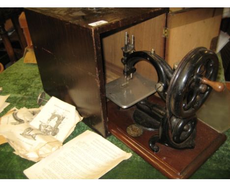 Willcox & Gibbs Sewing Machine Company, New York, black japanned and gilt decorated sewing machine on mahogany base with meda
