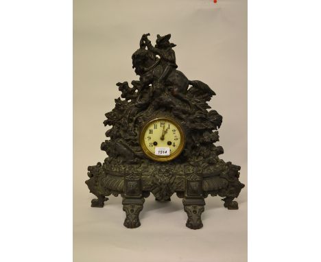 Large 19th Century black patinated cast iron mantel clock, decorated with a figure on horseback and various hunting related d