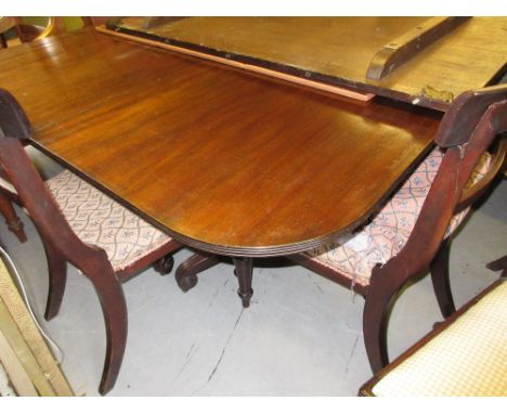 Mahogany D-end dining table, the reeded top with single extra leaf above twin turned column supports with tripod bases (19th 