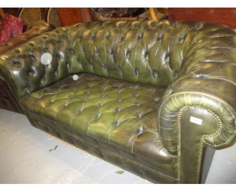 Green buttoned leather upholstered two seater Chesterfield sofa on low bun feet