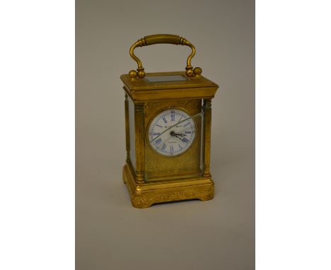 Small early 20th Century French gilt brass carriage clock, the enamel dial inscribed Elliot and Son, with floral engraved cas