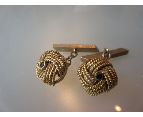 Pair of 9ct yellow gold knot design sapphire set cufflinks