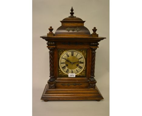 Late 19th Century Continental walnut mantel clock with a dome top above a square door flanked by spiral twist half columns, t