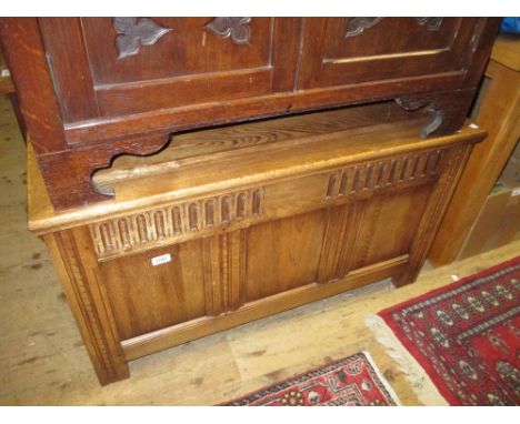 20th Century oak coffer having three panel front with carved decoration on stile end supports
