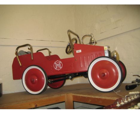 Child's red tin plate fire engine pedal car