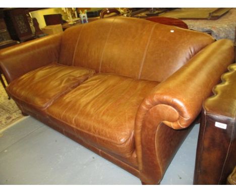 Large brown leather upholstered scroll end sofa, raised on low bun feet