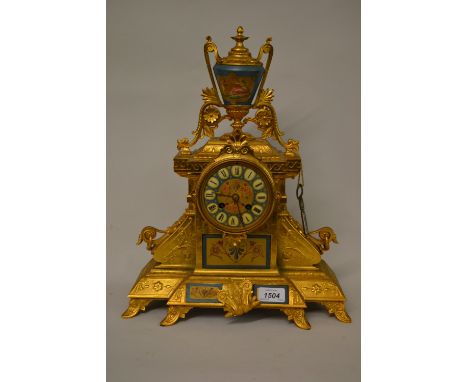 19th Century gilt spelter mantel clock having porcelain urn surmount and porcelain panels, with a matching circular dial havi