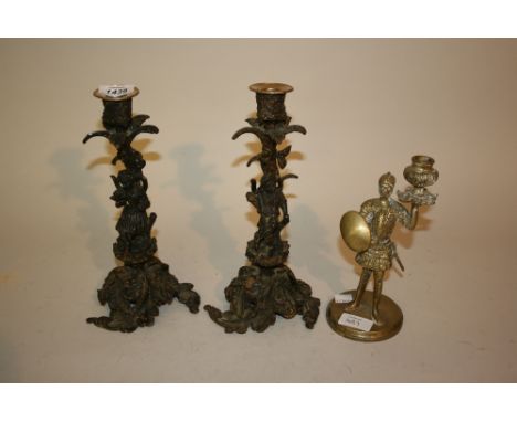 Pair of cast metal foliate and figural mounted candlesticks together with a brass candlestick in the form of a knight