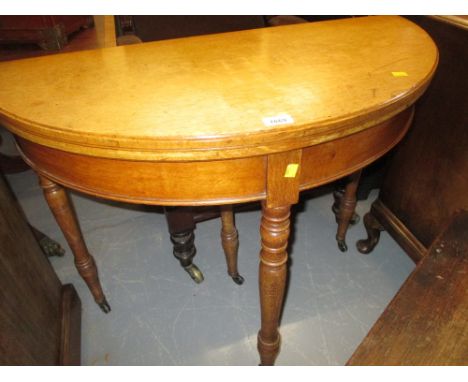 Late 19th Century pale oak demi lune fold-over card table raised on turned tapering supports