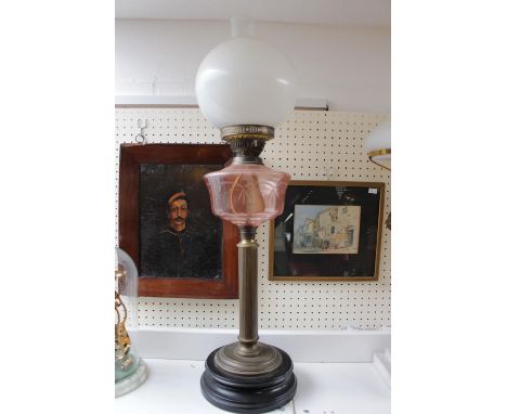 Edwardian Oil Lamp with Pink glass reservoir over Brass column and opaque spherical shade. 71cm in Height 