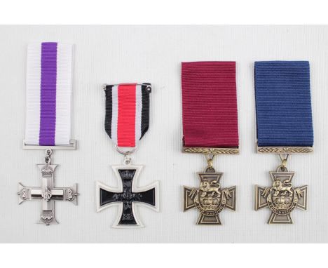Collection of 4 Reproduction Medals inc. German Iron cross, Victoria Cross Naval and Army, and another Cross 