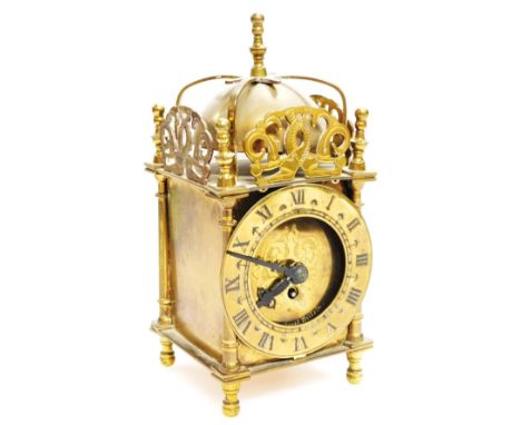 A mid 20thC Smiths brass lantern clock, with domed bell top, 1cm dia. Roman numeric chapter ring and shaped case revealing a 