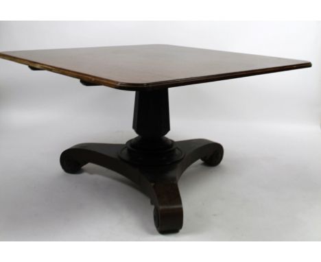 A mid 19thC mahogany snap top supper table, the moulded rounded square top raised on a heavy baluster column terminating in a