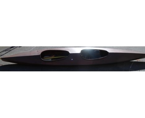 A stained two man wooden canoe, of typical outline, with accessories, 84cm wide (the widest point) x 485cm long (approx.)