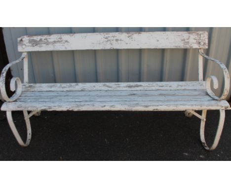 A painted wooden slatted garden bench with wrought iron frame, scroll arms and legs and plank top seat, with visible studs, 8
