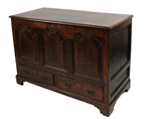 A 18thC oak mule chest, the overhanging top raised above a shaped three panel front above two drawers on ogee bracket feet, 8