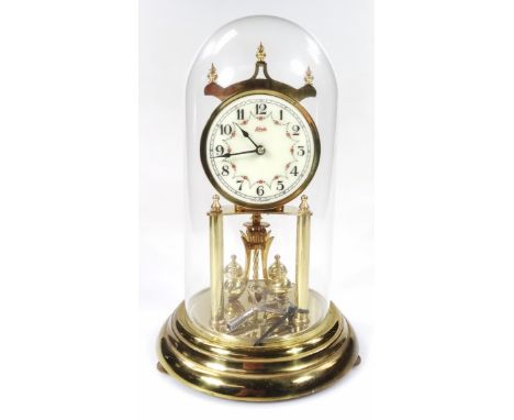 A mid 20thC Kunder Anniversary clock, 8cm dia. Arabic dial and glass dome, on stepped circular base, terminating in compresse