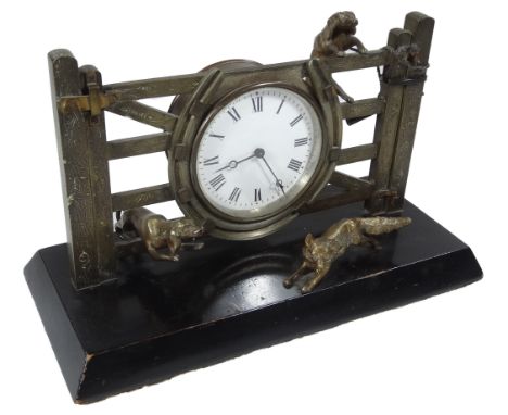 A 20thC brass novelty mantel clock, formed as a hunting scene, with a central 8cm dia. Roman numeric dial in gate being jumpe