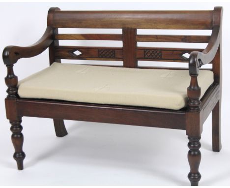 A Georgian style mahogany child's bench sofa, with horizontal back splat, shaped scroll arm supports and turned front legs, w