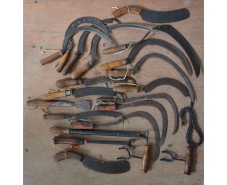 Collection of vintage farming tools, including swaps, billhooks, sickles, bale hooks etc. 